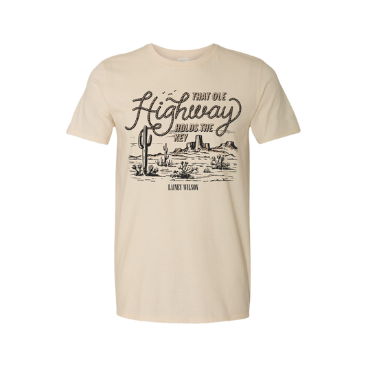 Beige t-shirt with a desert landscape and ’That Ole Highway’ text design.