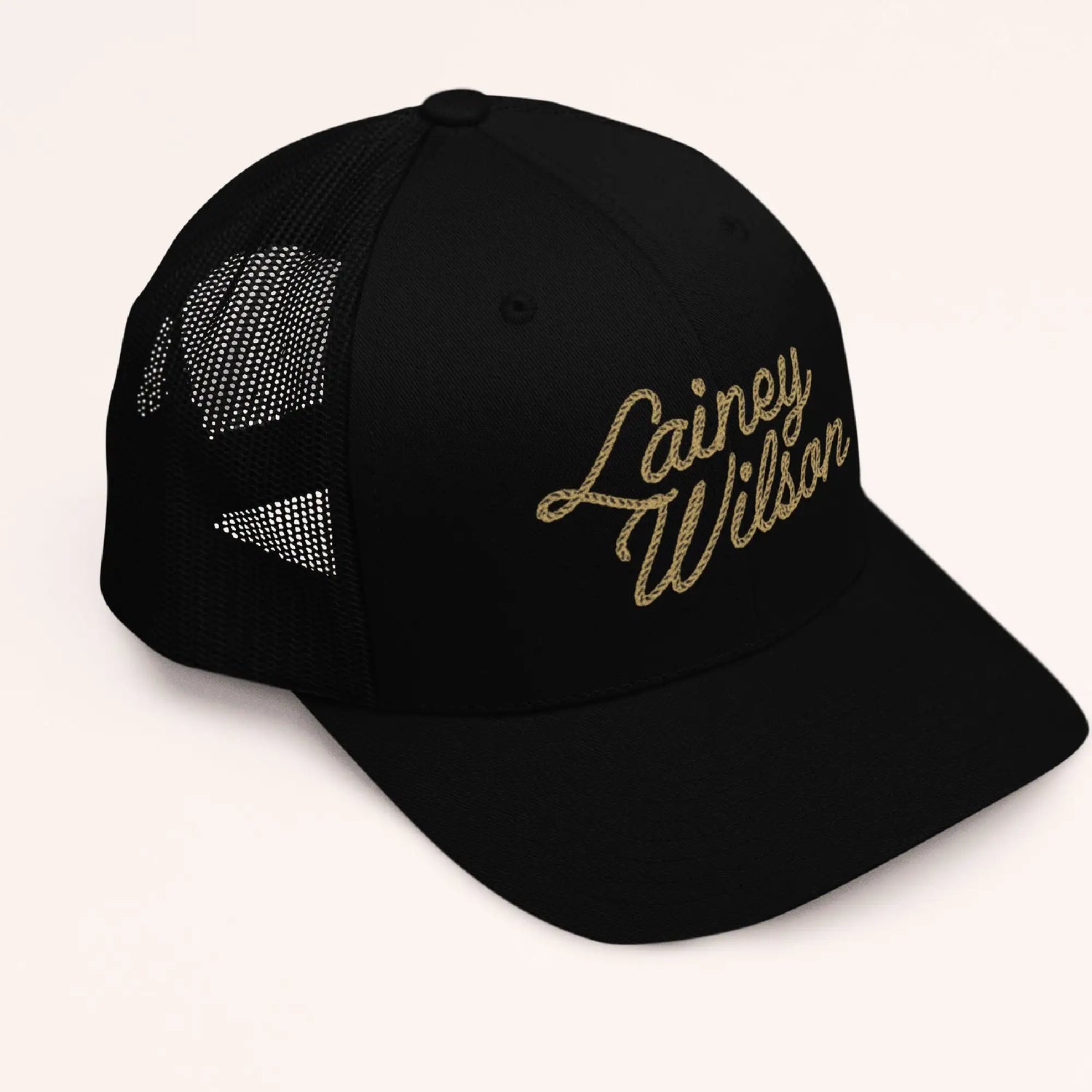 Black trucker hat with gold embroidered ’lainey wilson’ script on the front.