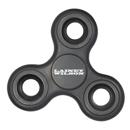 Black plastic fidget spinner with ’lainey wilson’ printed in white on the center.
