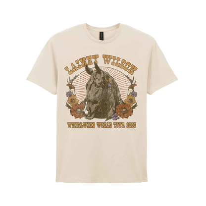 Cream-colored cotton t-shirt featuring a vintage-style graphic of a horse surrounded by flowers and the text ’lainey wilson’ above and ’whirlwind world tour 2023’’ below.