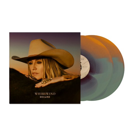 A beige cowboy hat worn by a woman with blonde hair, featuring a wide brim and a slightly curved crown.