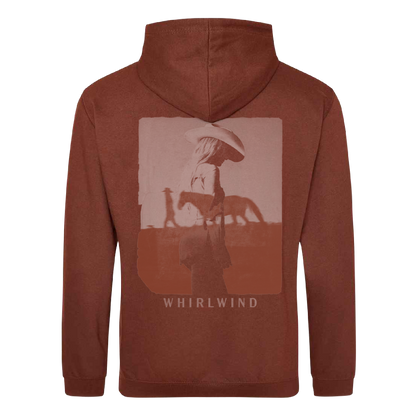 A rust-colored hoodie featuring a faded graphic of a person in a cowboy hat standing beside a horse, with the word ’whirlwind’ printed below.