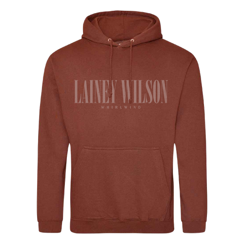 A rust-colored cotton hoodie featuring a front pocket and drawstrings with ’lainey wilson’ printed across the chest in matching tone.