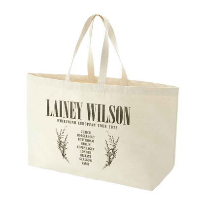 Cream-colored canvas tote bag with black printed text and botanical illustrations.