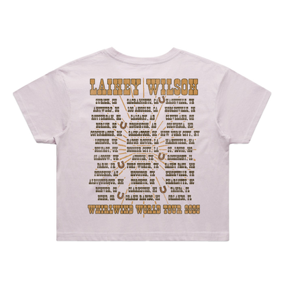 White t-shirt with brown text and horseshoe designs listing lainey wilson’s 2025 whirlwind world tour cities
