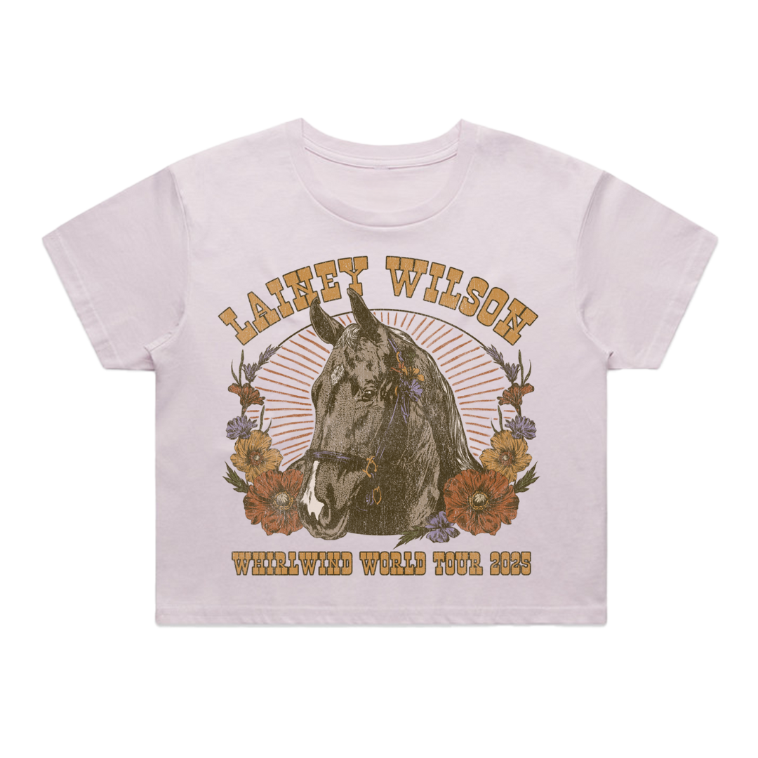 White cotton t-shirt featuring a vintage-style graphic of a horse surrounded by flowers and the text ’lainey wilson’ above and ’whirlwind world tour 2023’’ below.