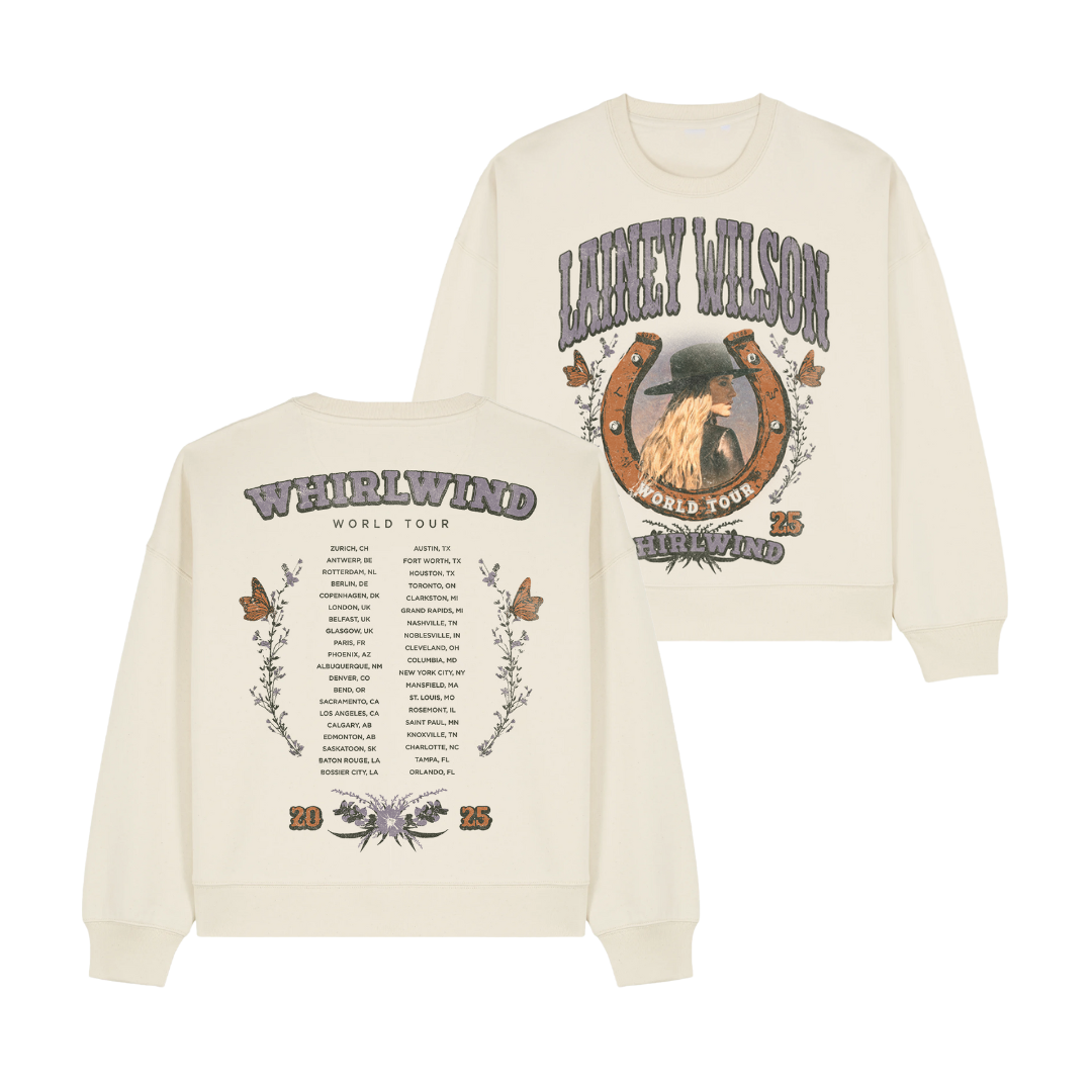 Cream-colored long-sleeve sweatshirt featuring a graphic of lainey wilson in a hat within a horseshoe design on the front and her ’weirwind world tour’ itinerary printed across the back.