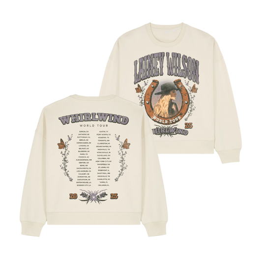 Cream-colored long-sleeve sweatshirt featuring a graphic of lainey wilson in a hat within a horseshoe design on the front and her ’weirwind world tour’ itinerary printed across the back.